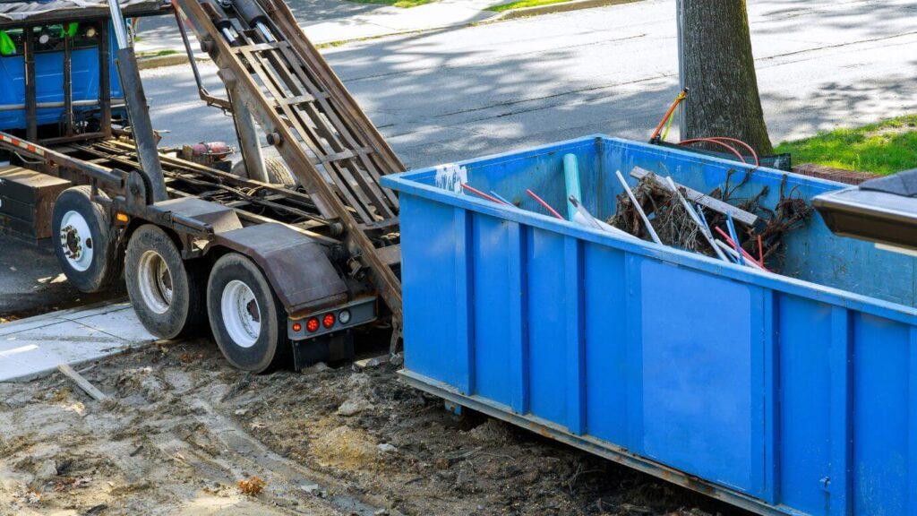 Dumpster being rolled off truck